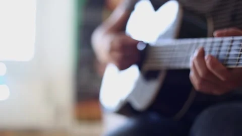 The man plays the guitar. The image is blurry Video stock 252325440