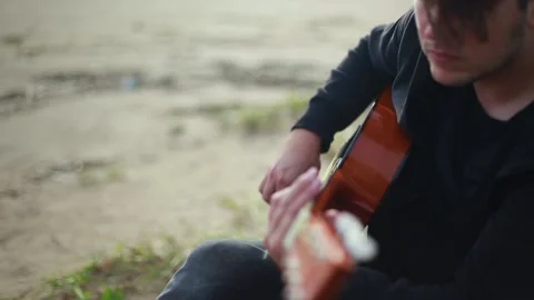 A man plays the guitar on the ocean. Stock Footage 152460181