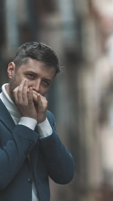 A man plays the harmonica on the street Against the background of a blurred Vidéo 328343269