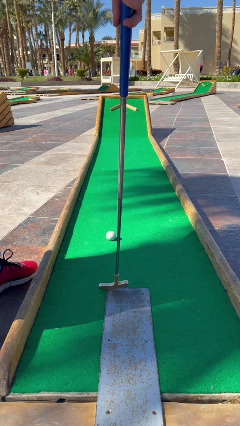 Man plays mini golf and misses. Mini golf game for family and kids Stock Footage 170858491