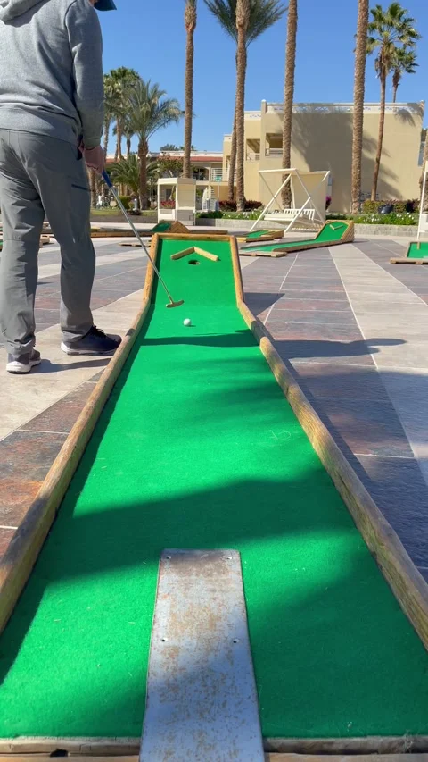 Man plays mini golf and misses. Mini golf game for family and kids. Hurghada Stock Footage 171546204