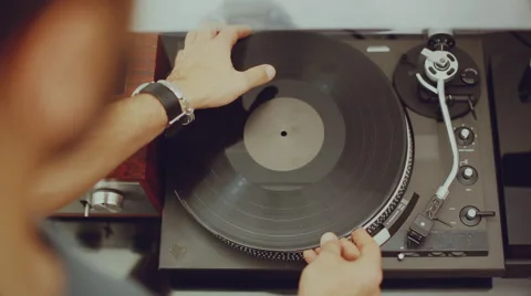 Man plays a record on his turntable Video stock 62640277