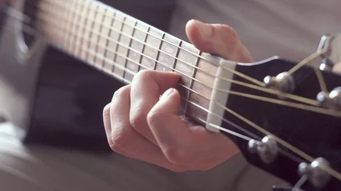 Man plays rolls or fingerpicking acoustic guitar. Black musical instrument. Stock Footage 116624974