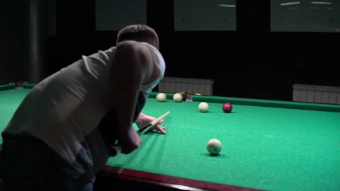 A man plays Russian billiards. Rolls a billiard ball into the pocket Video stock 147220127