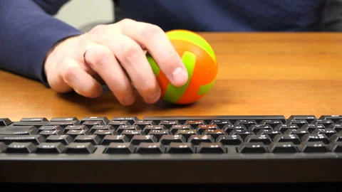 A man plays with a small ball on the desktop Stock Footage 99861888