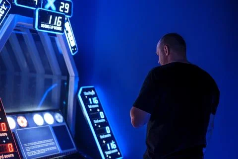 A man plays a soccer game simulator in an entertainment center Foto stock