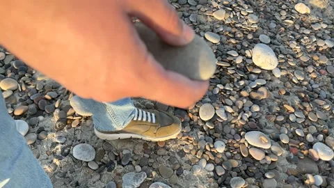 Man plays with stone Stock Footage 261672430