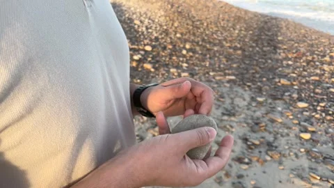 Man plays with stone Stock Footage 261672449