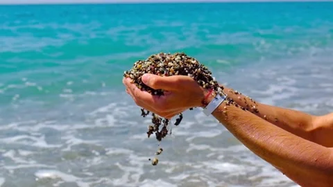 A man plays with stones on the beach. Selective focus. Stock Footage 168682341