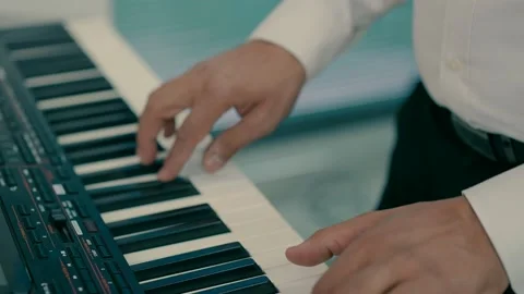 A man plays a synthesizer Stock Footage 233967943