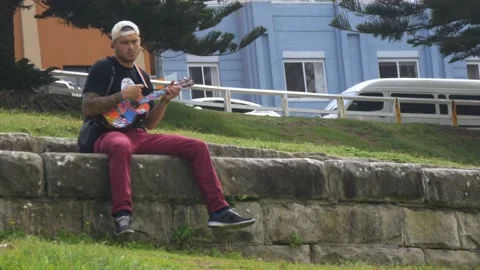 Man Plays Ukulele At Bondi Beach In Sydney, New South Wales, Australia Stock Footage 158880019