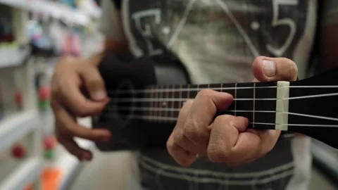 A man plays the ukulele Stock-Footage 136812689