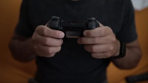 Man plays a video game. Close up of hands. Recreation and play time Video stock 136291381