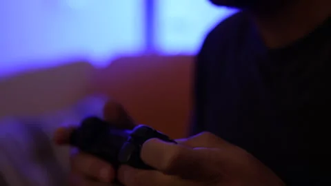 Man plays a video game. Close up of hands. Recreation and play time Video stock 136464202