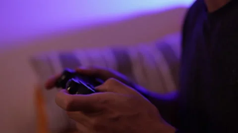 Man plays a video game. Close up of hands. Recreation and play time Stock Footage 136464711