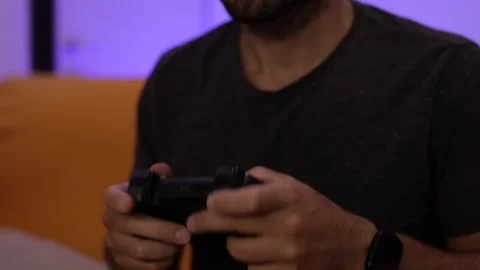 Man plays a video game. Close up of hands. Recreation and play time Video stock 136464794