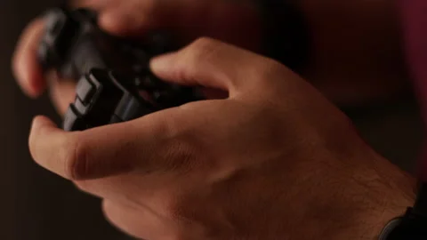 Man plays a video game. Close up of hands. Recreation and play time Video stock 136536773