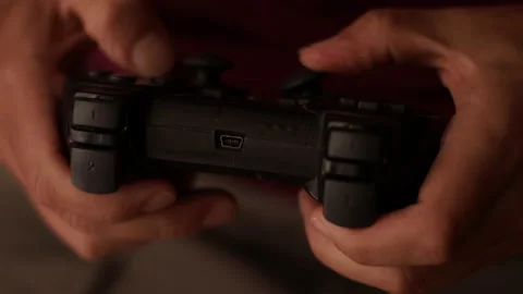 Man plays a video game. Close up of hands. Recreation and play time Video stock 136537149