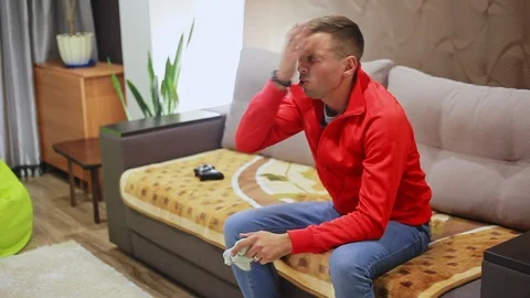 Man plays a video game on the console at home, lost Stock Footage 95930269