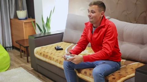 Man plays a video game on the console, win Stock Footage 95930316