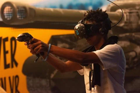 A man plays a video game using virtual reality glasses Stock Photos