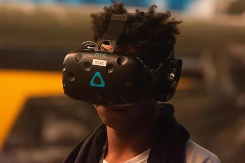 A man plays a video game using virtual reality glasses Stock Photos