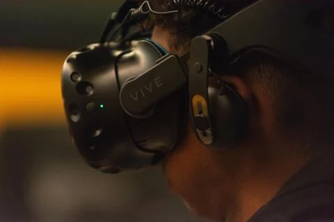 A man plays a video game using virtual reality glasses Stock Photos