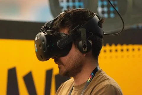 A man plays a video game using virtual reality glasses Stock Photos