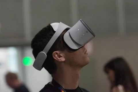 A man plays a video game using virtual reality glasses Stock Photos