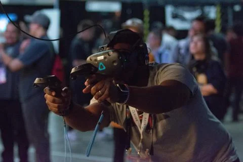 A man plays a video game using virtual reality glasses Stock Photos