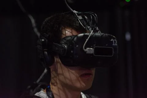 A man plays a video game using virtual reality glasses 写真素材