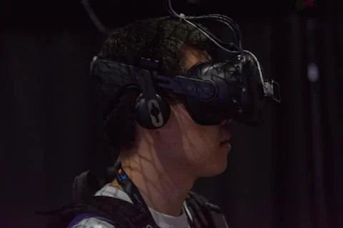 A man plays a video game using virtual reality glasses Stock Photos