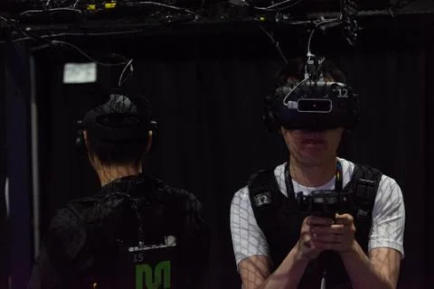 A man plays a video game using virtual reality glasses Stock Photos