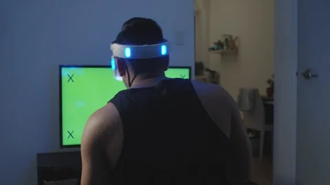 Man Plays Virtual Reality Game with Hand Controller and Reacts, Green Screen Stock Footage 108880806