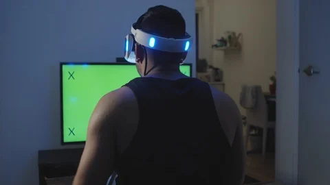 Man Plays Virtual Reality Game with Hand Controller and Reacts, Green Screen Stock Footage 108880829