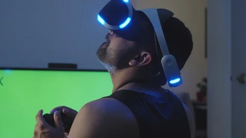 Man Plays Virtual Reality Game with Controller and Looks Around, Green Screen Stock Footage 108880865