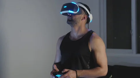 Man Plays Virtual Reality Game with Controller and Looks Around at Night Closeup Stock Footage 108881462