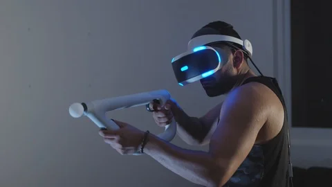 Man Plays Virtual Reality Video Game with Gun and Goggles in Living Room, Night Stock Footage 108880577