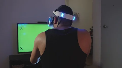 Man Plays Virtual Reality Video Game with Gun and Goggles, Green Screen Stock Footage 108880941