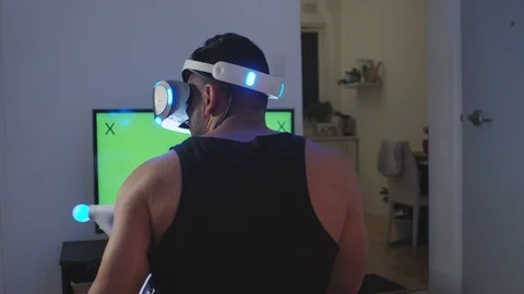 Man Plays Virtual Reality Video Game with Gun and Goggles, Green Screen Stock Footage 108880957