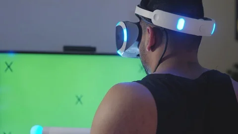 Man Plays Virtual Reality Video Game with Gun and Goggles, Green Screen Stock Footage 108881055
