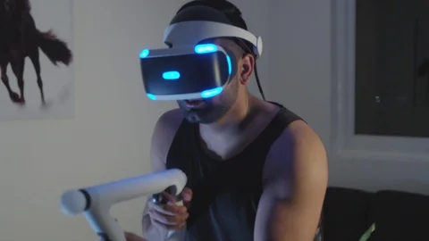 Man Plays Virtual Reality Video Game with Gun and Goggles in Living Room, Night Stock Footage 108881171