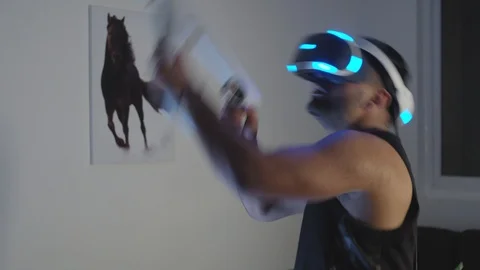 Man Plays Virtual Reality Video Game with Gun and Goggles in Living Room, Night Stock Footage 108881228