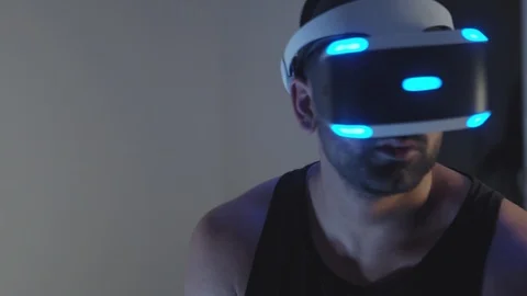 Man Plays Virtual Reality Video Game with Gun and Goggles in Living Room, Night Stock Footage 108881292