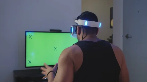 Man Plays Virtual Reality Video Game with Gun and Goggles, Green Screen Stock Footage 108882193
