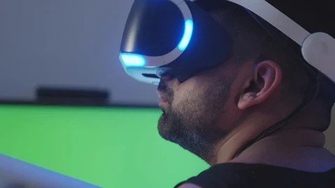 Man Plays Virtual Reality Video Game with Gun and Goggles, Green Screen Stock Footage 108882320