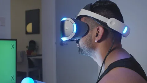 Man Plays Virtual Reality Video Game with Gun and Goggles, Green Screen Stock Footage 108882461