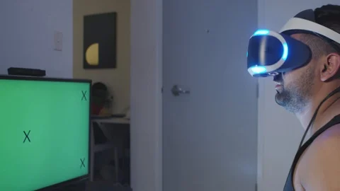 Man Plays Virtual Reality Video Game with Gun and Goggles, Green Screen Stock Footage 108882509