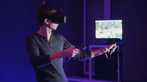 Man plays VR video game in vr club Stock Footage 99745678
