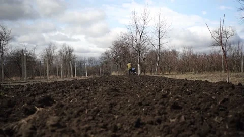 A man is plowing the land with a tractor Stock Footage 151595909